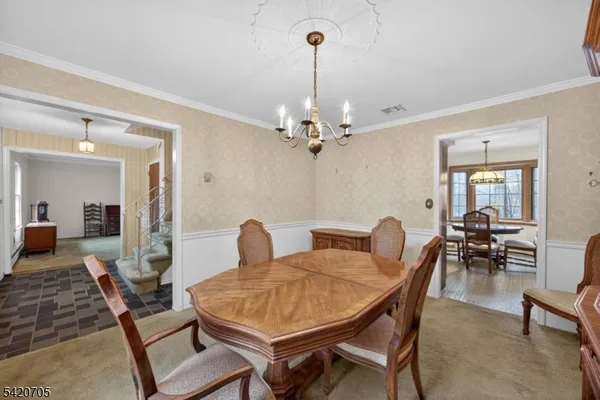 a bedroom with a large bed a flat tv screen and a dresser