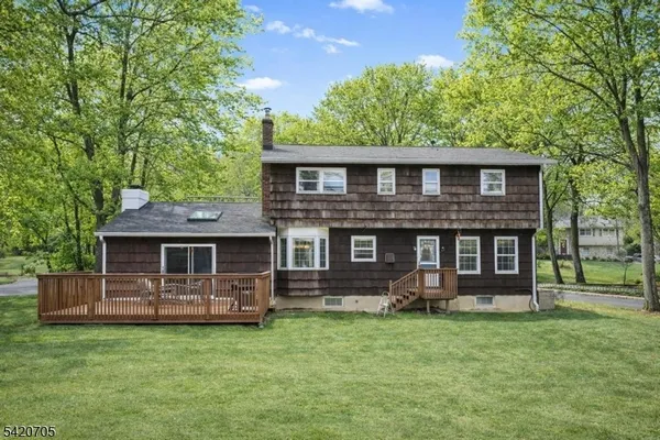a view of a roof deck with table and chairs and wooden floor