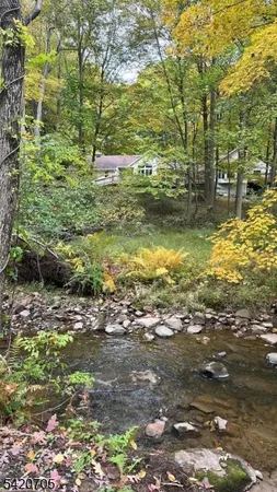 a living room with furniture gym equipment and a view of kitchen