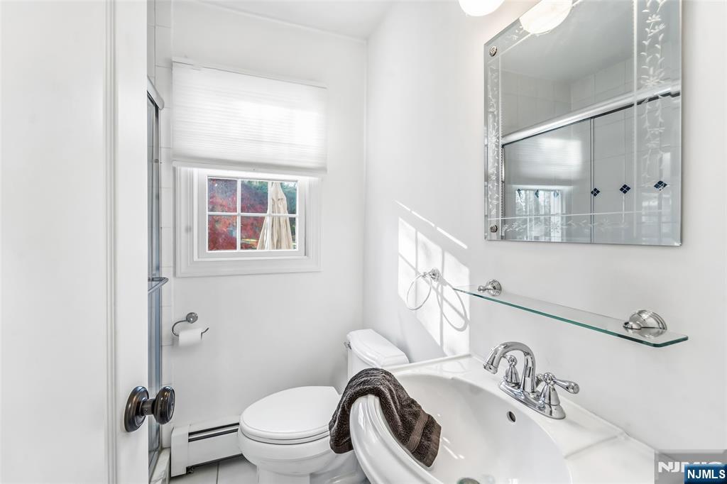 27 Pine Hill Road Old Tappan, NJ 07675 - Photo 17 of 50 a bathroom with a sink a toilet and a mirror