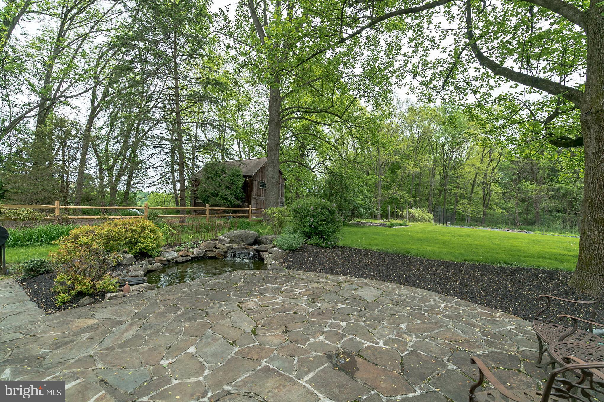 130 Indiantown Road Glenmoore, PA 19343 - Photo 32 of 37 Fieldstone terrace w/ barn in distance