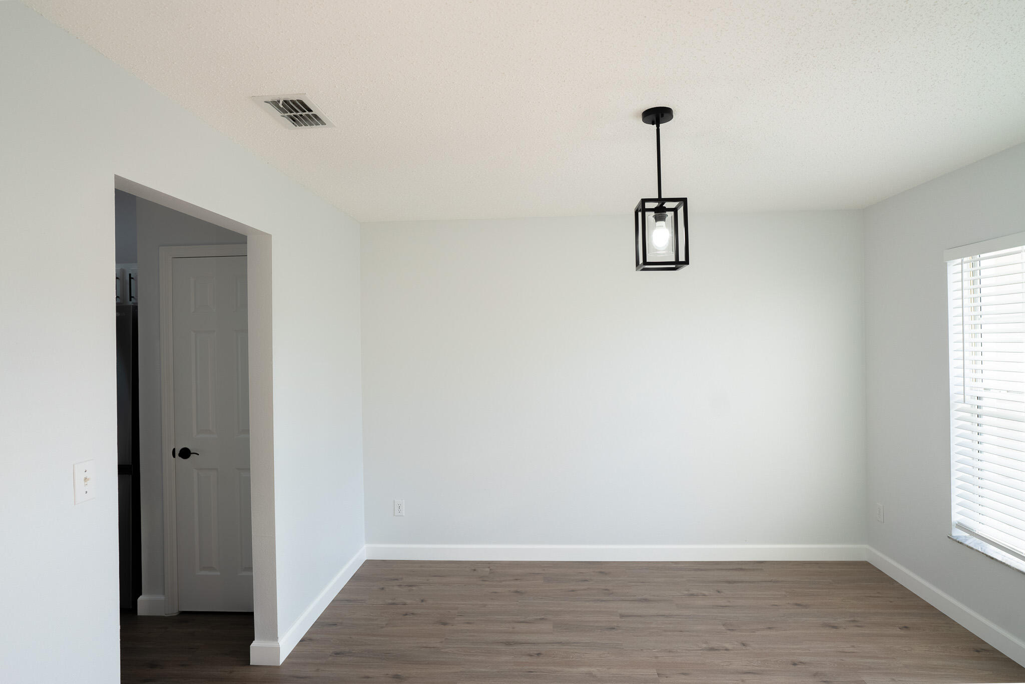 2001 Southwest Ember Street Port St. Lucie, FL 34953 - Photo 11 of 22 a view of a room with wooden floor and windows