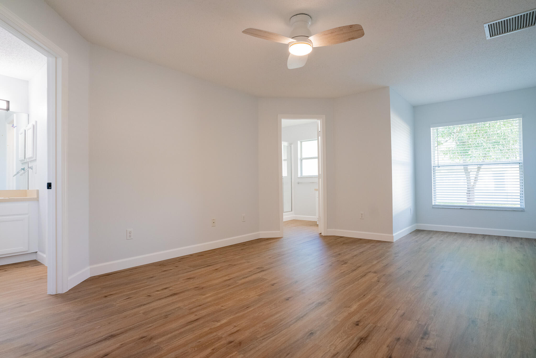 2001 Southwest Ember Street Port St. Lucie, FL 34953 - Photo 12 of 22 an empty room with wooden floor and windows