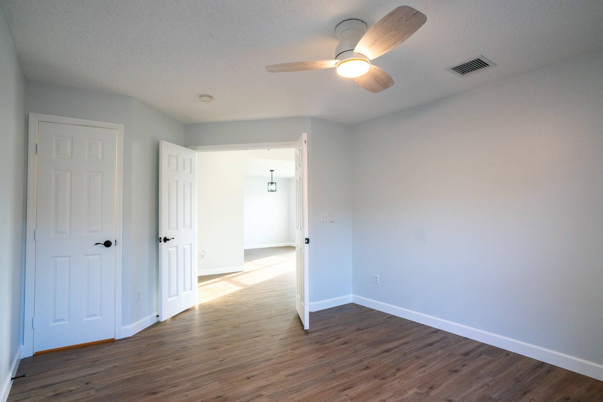 2001 Southwest Ember Street Port St. Lucie, FL 34953 - Photo 16 of 22 a view of an empty room and wooden floor