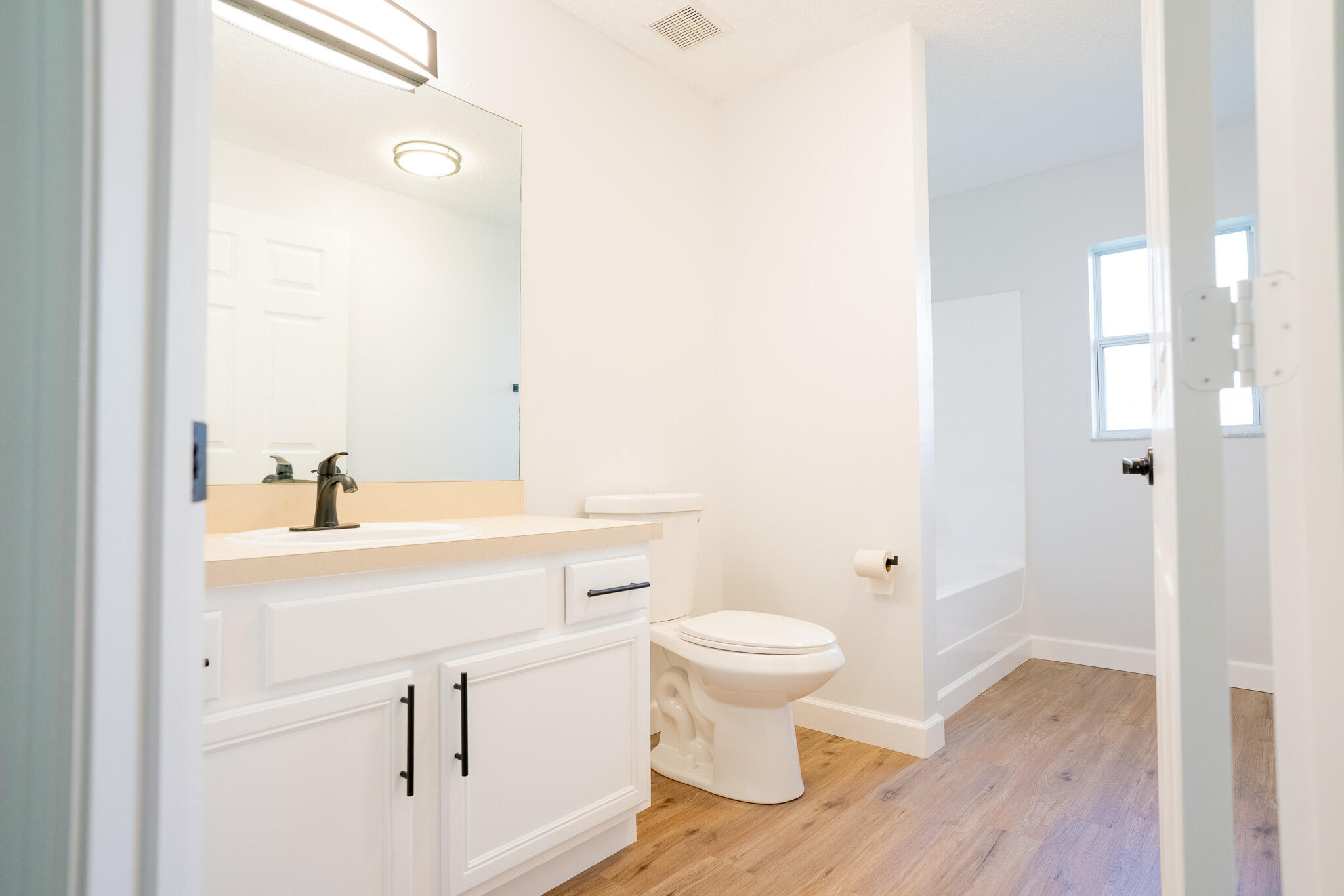 2001 Southwest Ember Street Port St. Lucie, FL 34953 - Photo 19 of 22 a bathroom with a sink toilet a mirror and shower