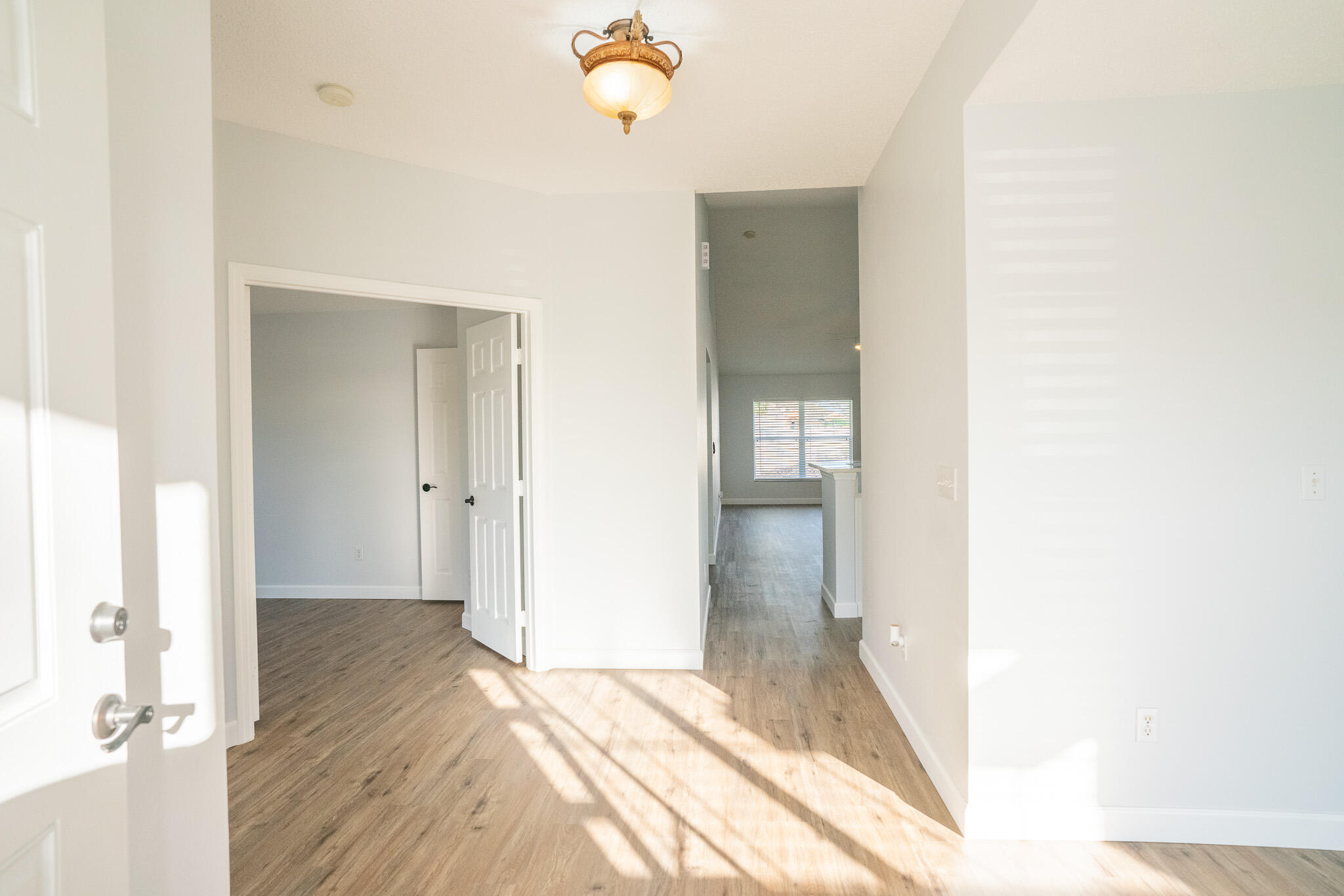 2001 Southwest Ember Street Port St. Lucie, FL 34953 - Photo 2 of 22 a view of a hallway with wooden floor and staircase
