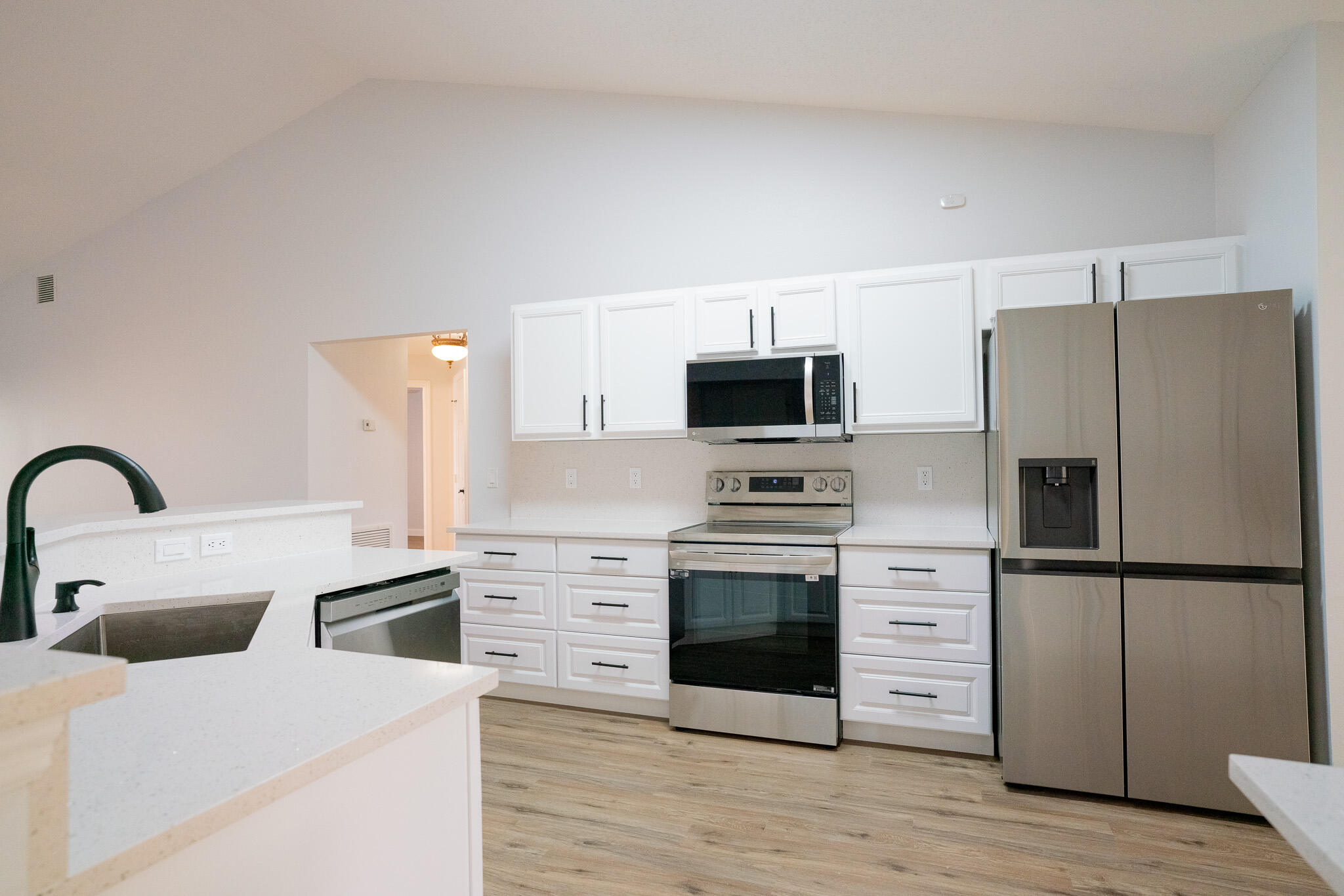 2001 Southwest Ember Street Port St. Lucie, FL 34953 - Photo 6 of 22 a kitchen with stainless steel appliances a stove microwave and refrigerator
