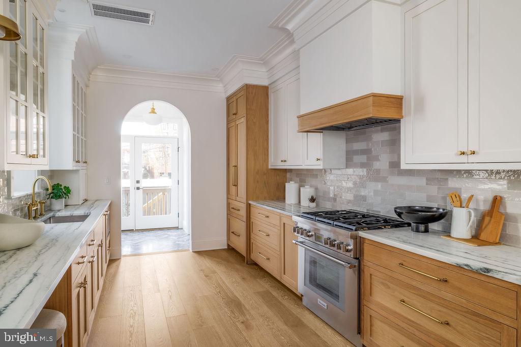 2460 Ontario Road Northwest Washington, DC 20009 - Photo 20 of 85 a kitchen with stainless steel appliances granite countertop a stove a sink and a refrigerator