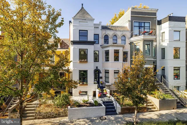 a front view of a residential apartment building with a yard