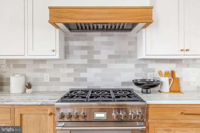 a bedroom with a bed a window and dresser