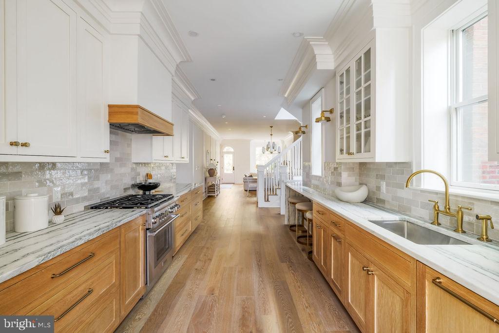 2460 Ontario Road Northwest Washington, DC 20009 - Photo 22 of 85 a kitchen with stainless steel appliances a sink stove and cabinets