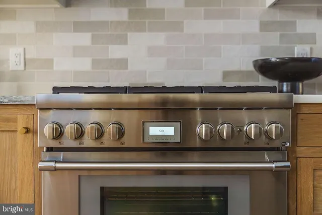 a bathroom with a granite countertop sink a mirror and shower