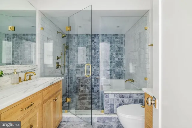 a view of a hallway with sink and wooden floor