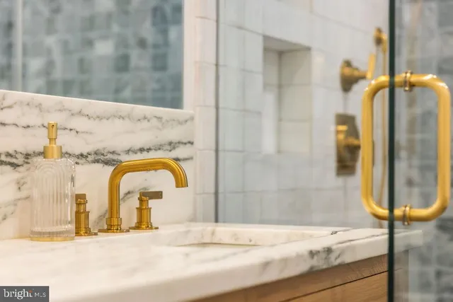 a living room with furniture and a wall painting