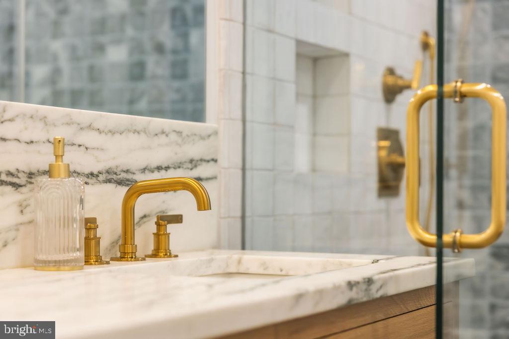2460 Ontario Road Northwest Washington, DC 20009 - Photo 39 of 85 a bathroom with a granite countertop sink and a mirror