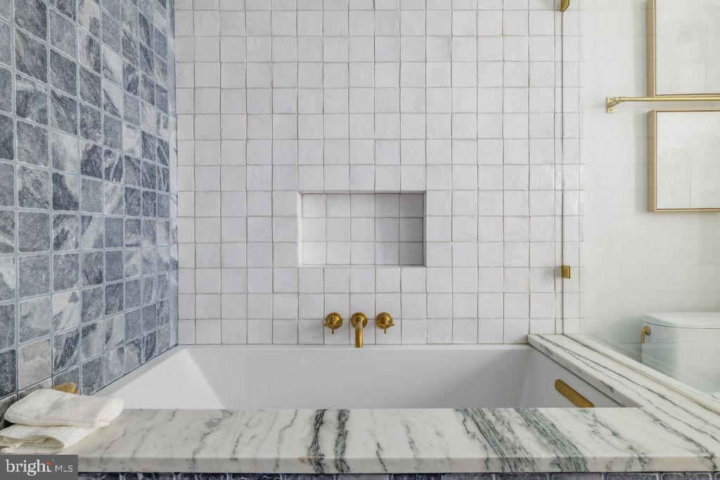 2460 Ontario Road Northwest Washington, DC 20009 - Photo 43 of 85 a bathroom with a bathtub and a shower