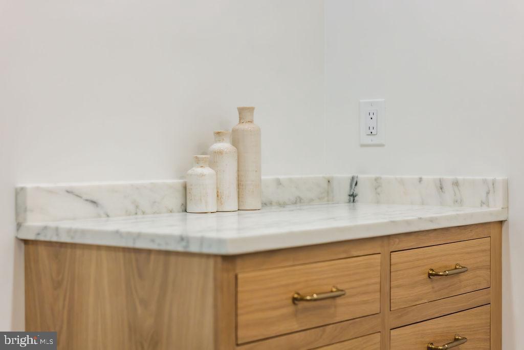 2460 Ontario Road Northwest Washington, DC 20009 - Photo 47 of 85 a bathroom with a granite countertop sink and a mirror