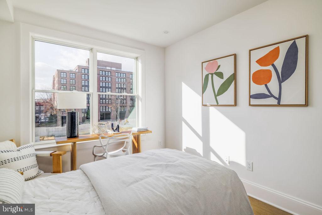 2460 Ontario Road Northwest Washington, DC 20009 - Photo 50 of 85 a large bed sitting in a bedroom next to a window