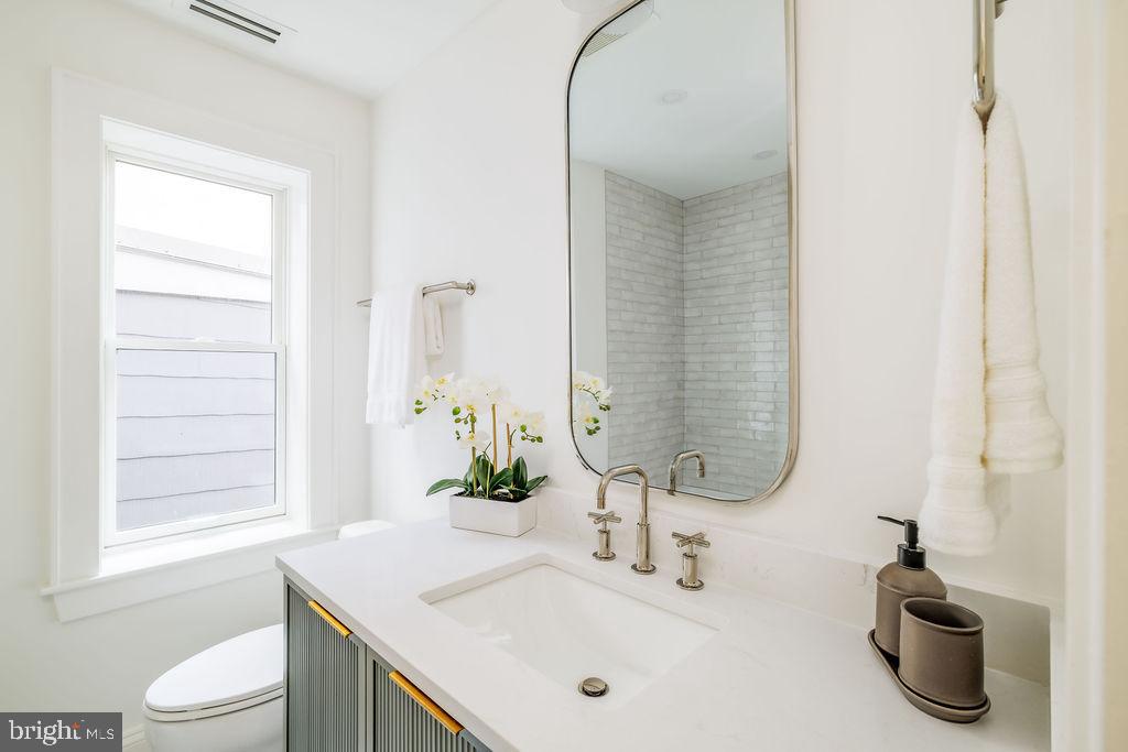 2460 Ontario Road Northwest Washington, DC 20009 - Photo 53 of 85 a bathroom with a sink and a toilet