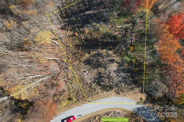 a view of a yard with wooden fence