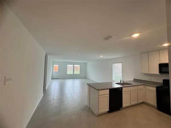 a kitchen with sink and cabinets