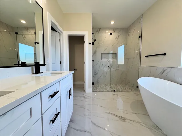 a bathroom with a white bath tub and shower