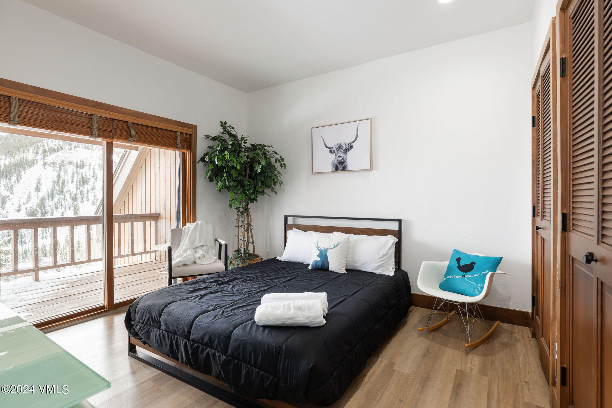 377 Holden Road Beaver Creek, CO 81620 - Photo 19 of 33 a bedroom with a bed a mirror and a potted plant