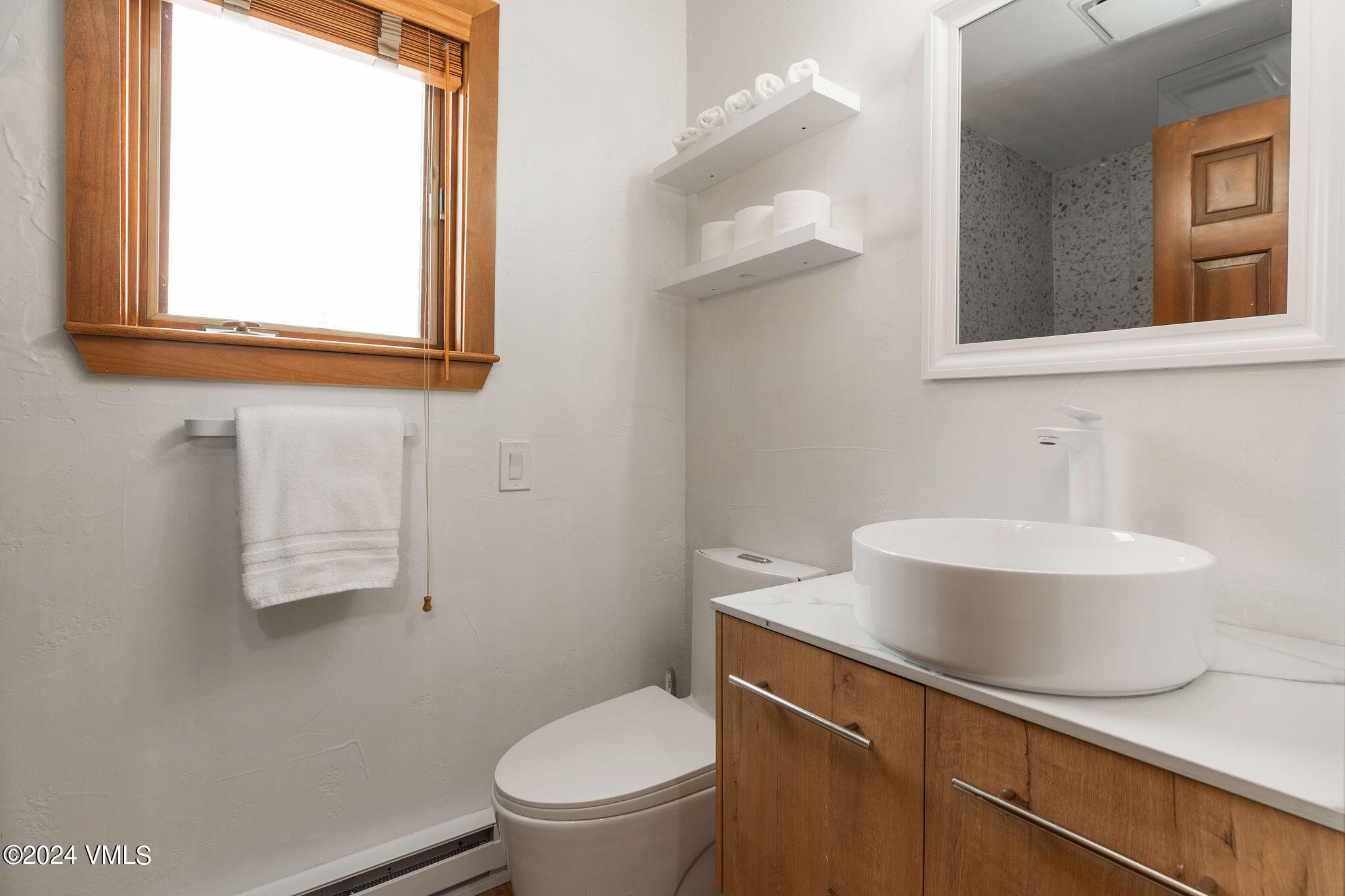 377 Holden Road Beaver Creek, CO 81620 - Photo 20 of 33 a white toilet sitting next to a bathroom sink