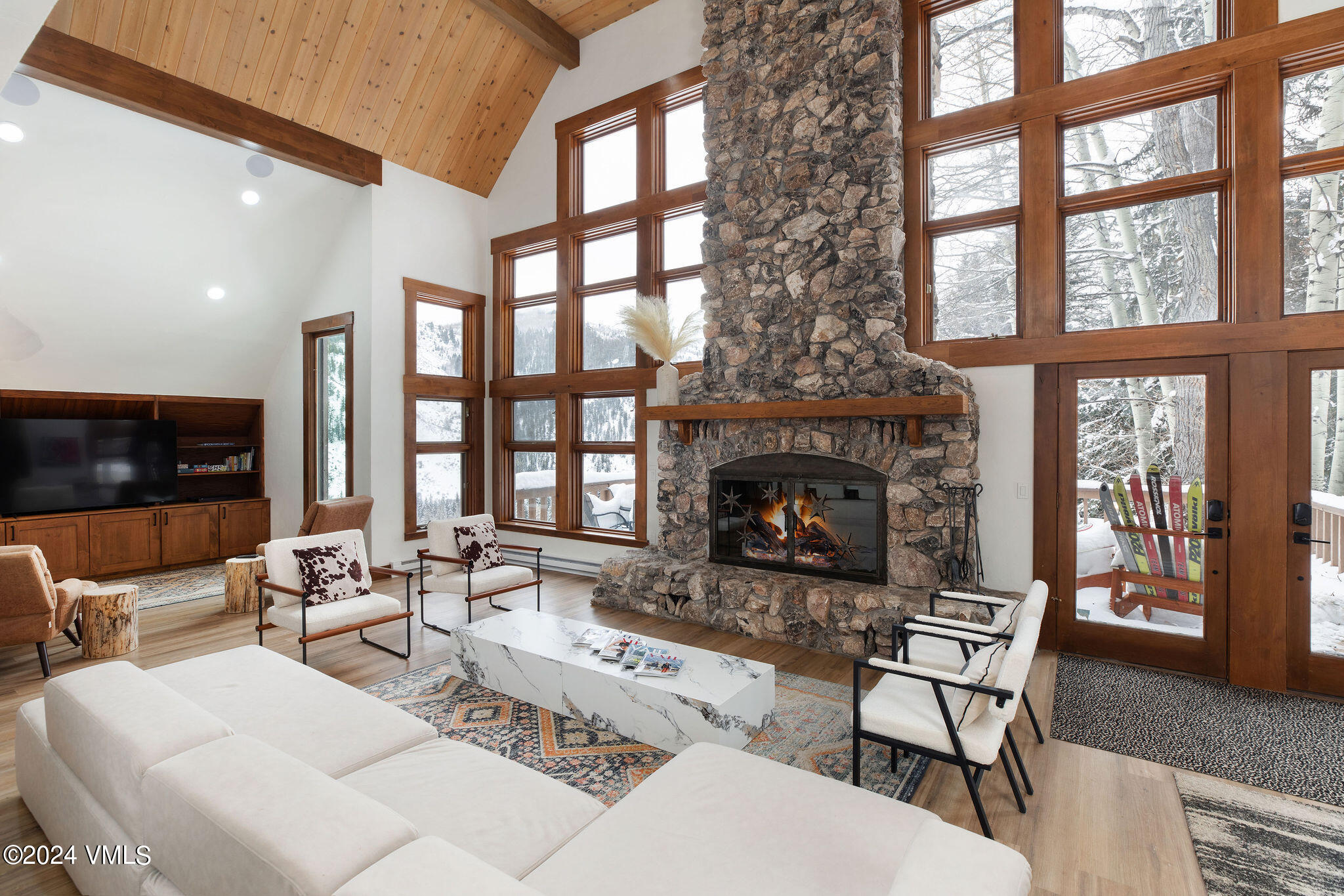 377 Holden Road Beaver Creek, CO 81620 - Photo 2 of 33 a living room with furniture a flat screen tv and a fireplace