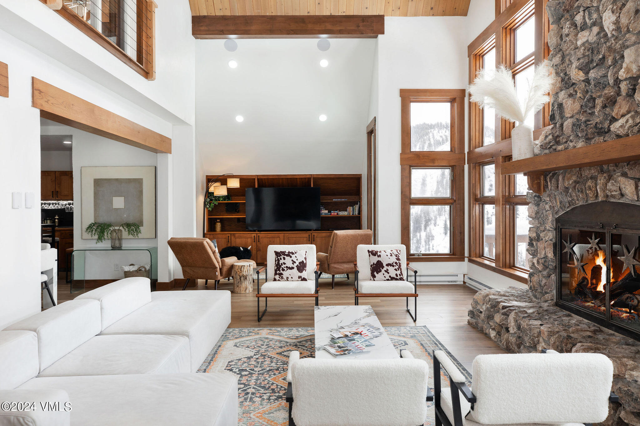 377 Holden Road Beaver Creek, CO 81620 - Photo 3 of 33 a living room with furniture large window and flat screen tv