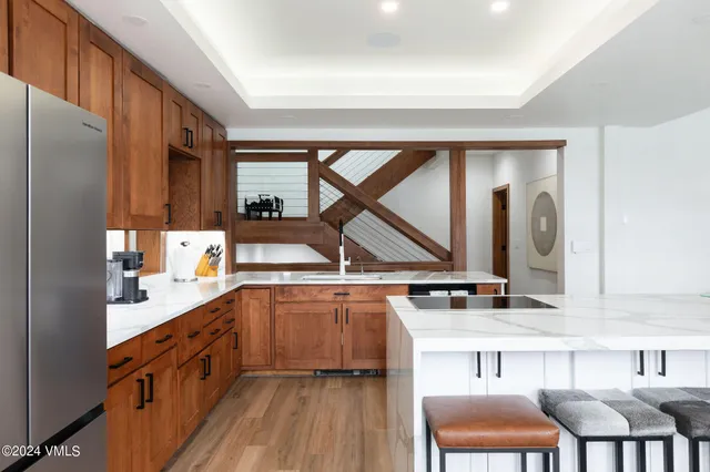 a kitchen with a sink window and cabinets