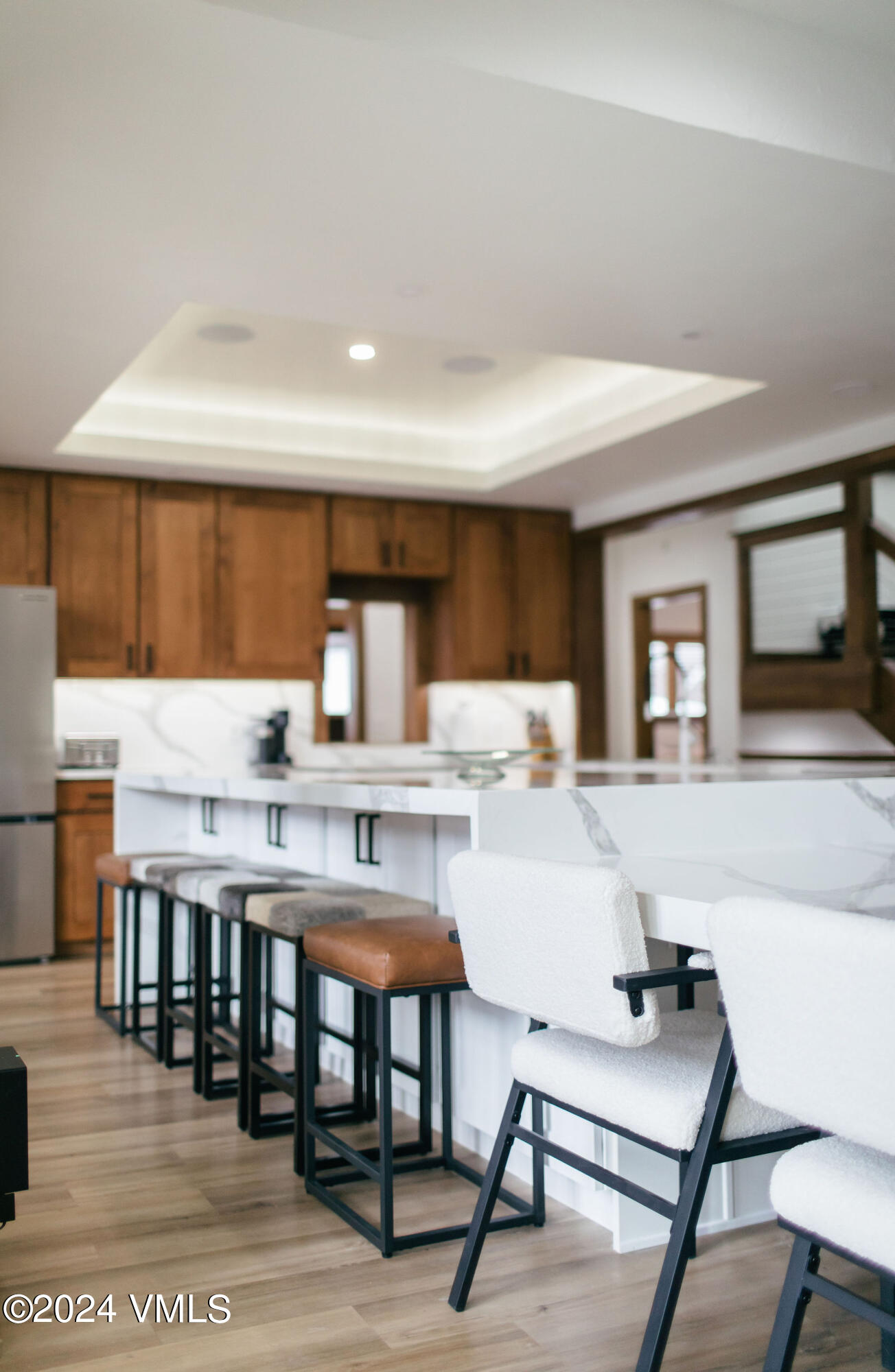 377 Holden Road Beaver Creek, CO 81620 - Photo 6 of 33 a kitchen with a table chairs and a refrigerator