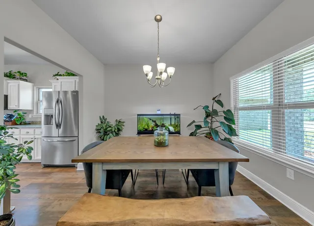 a view of a dining room with furniture window and outside view