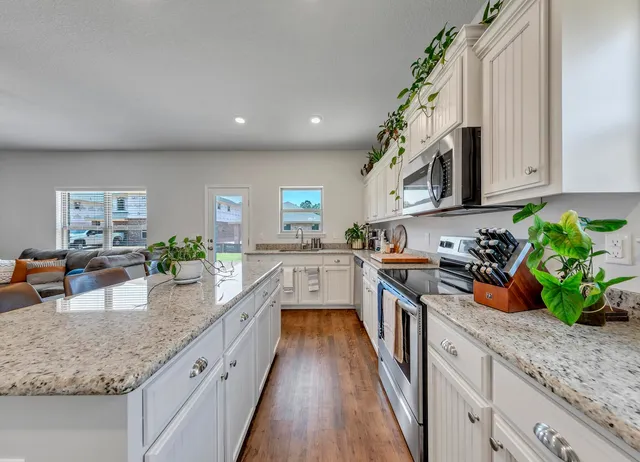 a kitchen with stainless steel appliances a refrigerator sink and cabinets