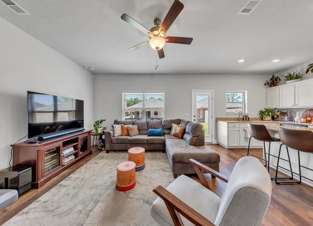 a living room with furniture and a large window