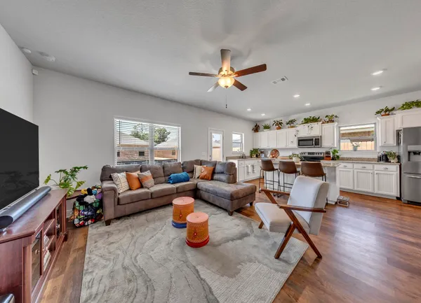 a living room with a couch and a potted plant