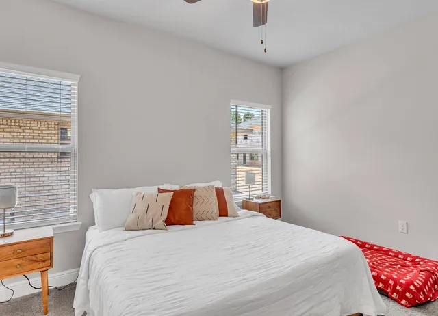 a spacious bathroom with a granite countertop sink a mirror and a shower
