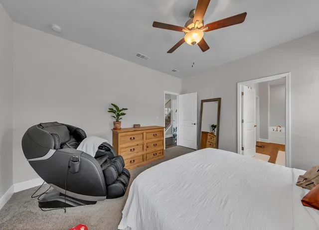 a bathroom with double vanity sinks a vanity a lamp and a mirror