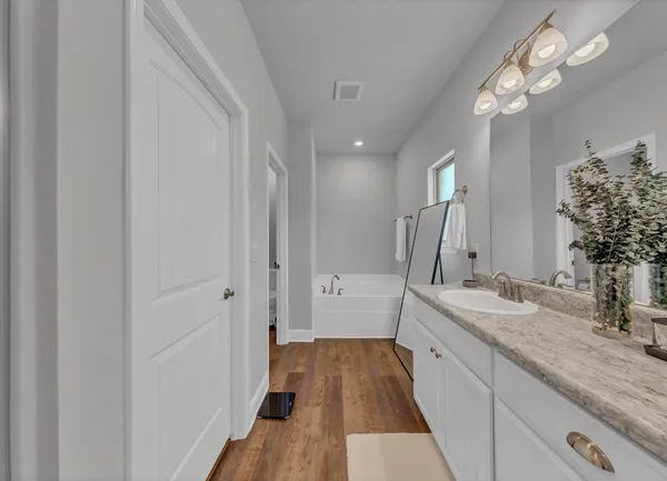 a spacious bathroom with a double vanity sink a mirror and shower