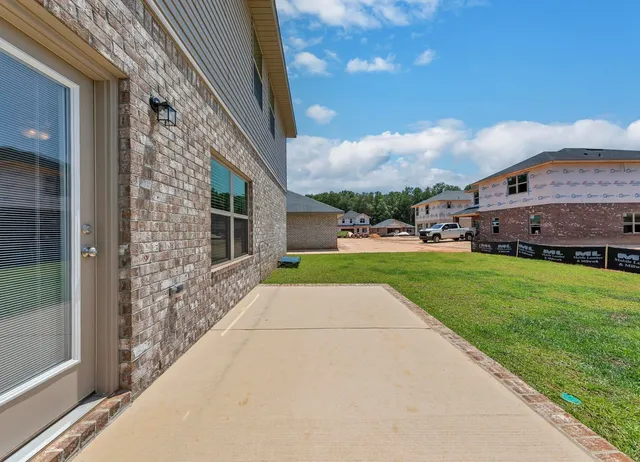 a view of house with backyard space and balcony