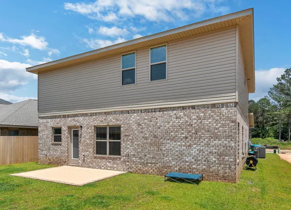 a front view of a house with yard and garage