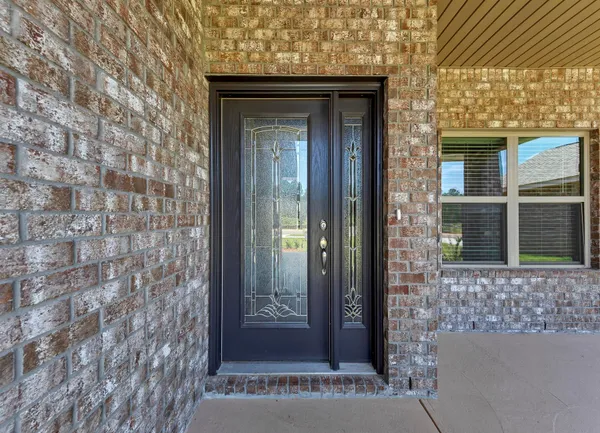 a view of a brick house with a door and balcony