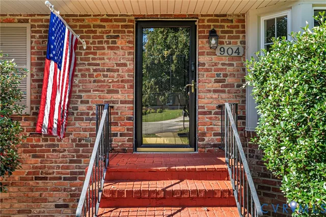 a view of empty room with wooden floor and fireplace