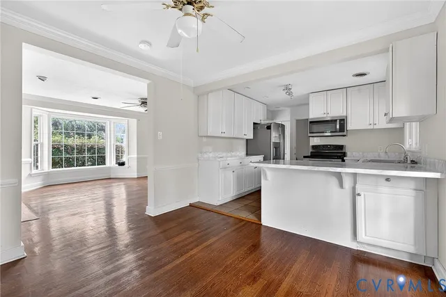 a kitchen with stainless steel appliances granite countertop a refrigerator stove microwave and sink