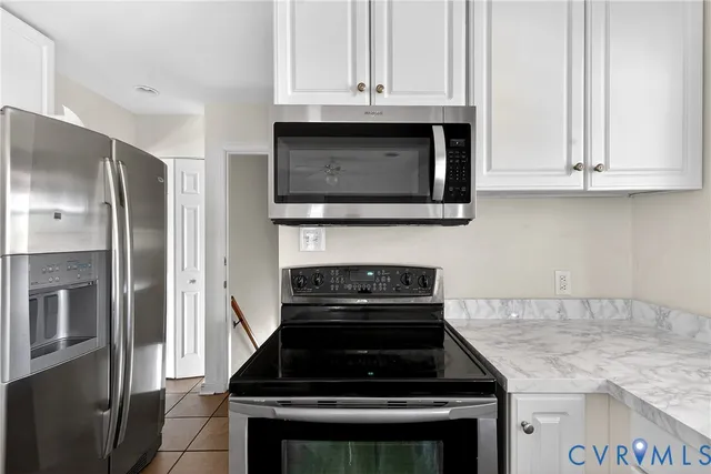 a view of a workspace with wooden floor and a window
