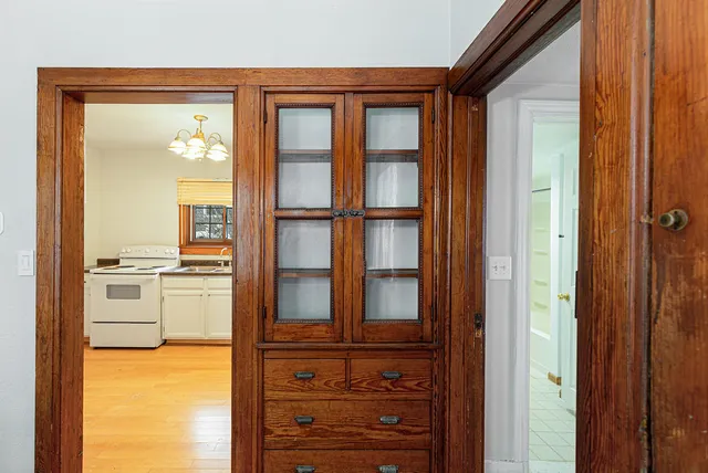 a view of a kitchen with a refrigerator and cabinets