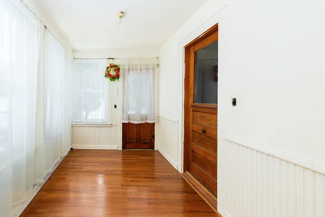 a view of a hallway view with wooden floor and staircase
