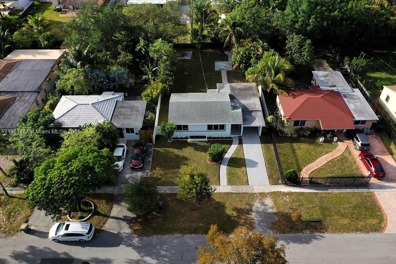 an aerial view of houses with yard