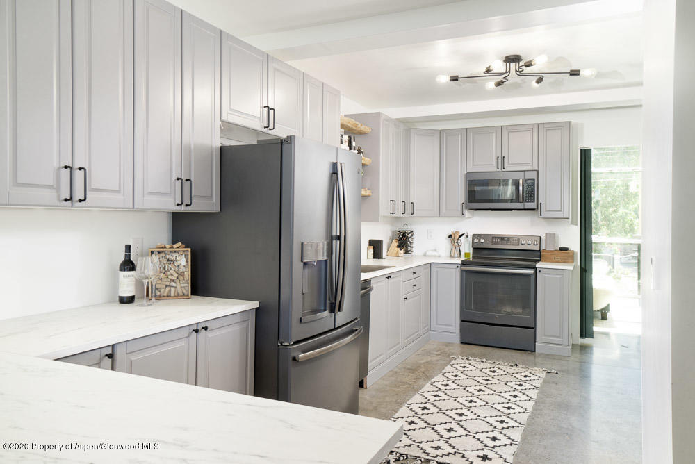 28 Widget Street, Unit 415 Basalt, CO 81621 - Photo 5 of 12 a kitchen with a refrigerator stove and sink