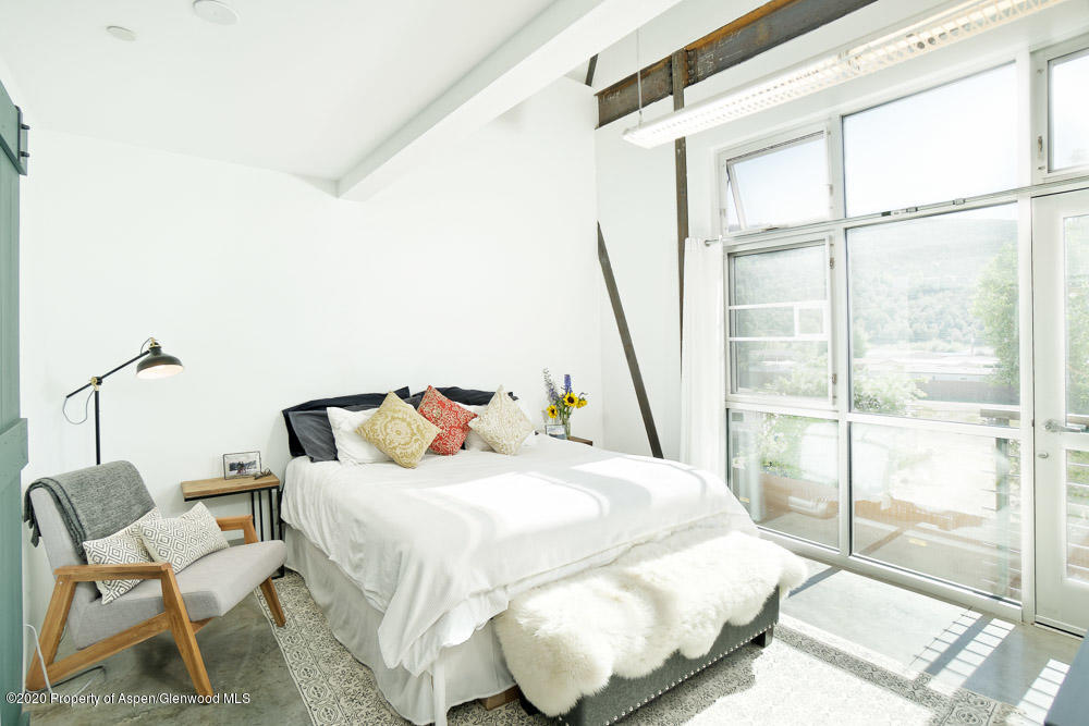 28 Widget Street, Unit 415 Basalt, CO 81621 - Photo 6 of 12 a bedroom with a bed and a large window